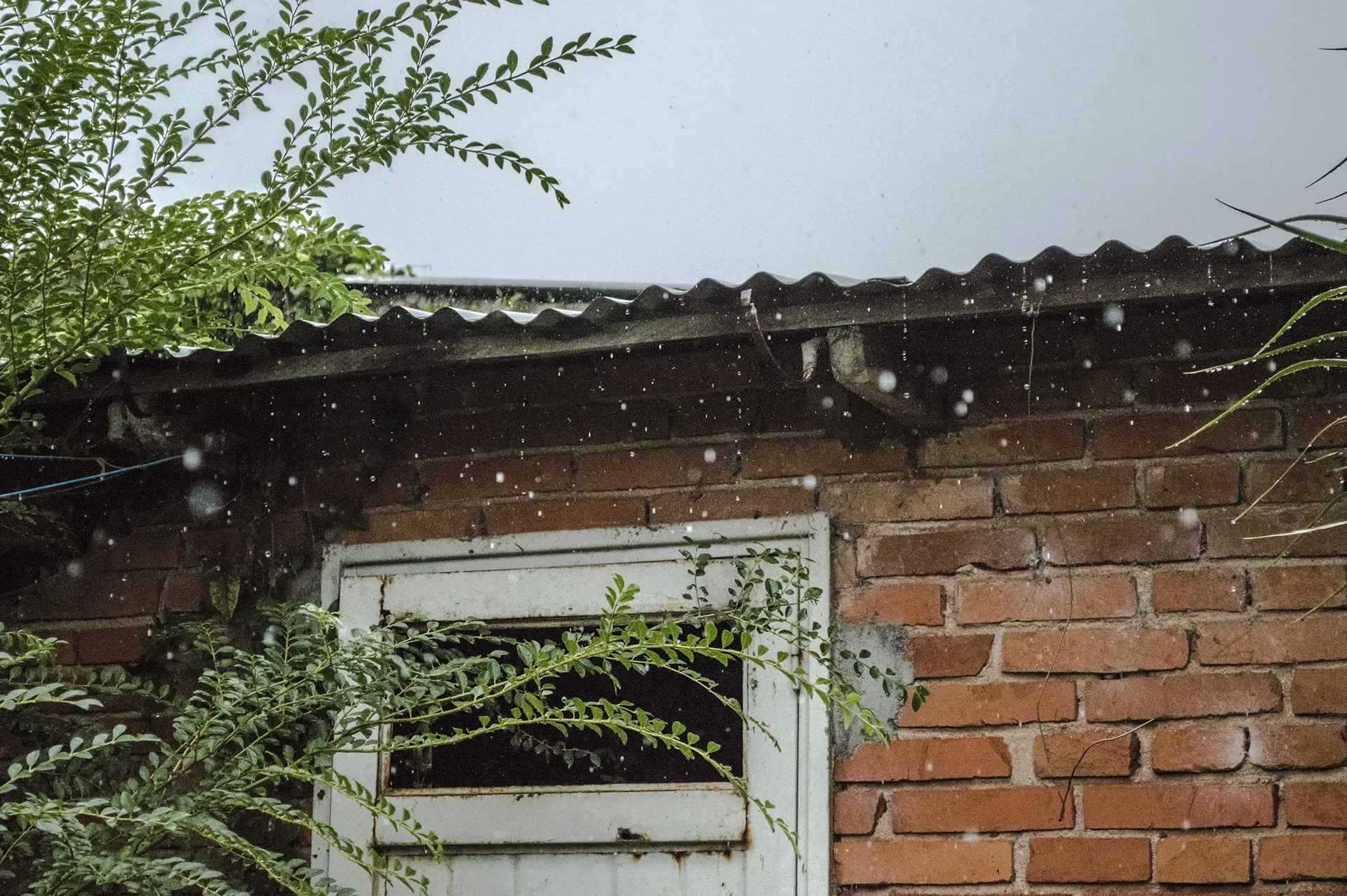 Heavy rain falling on a residential property